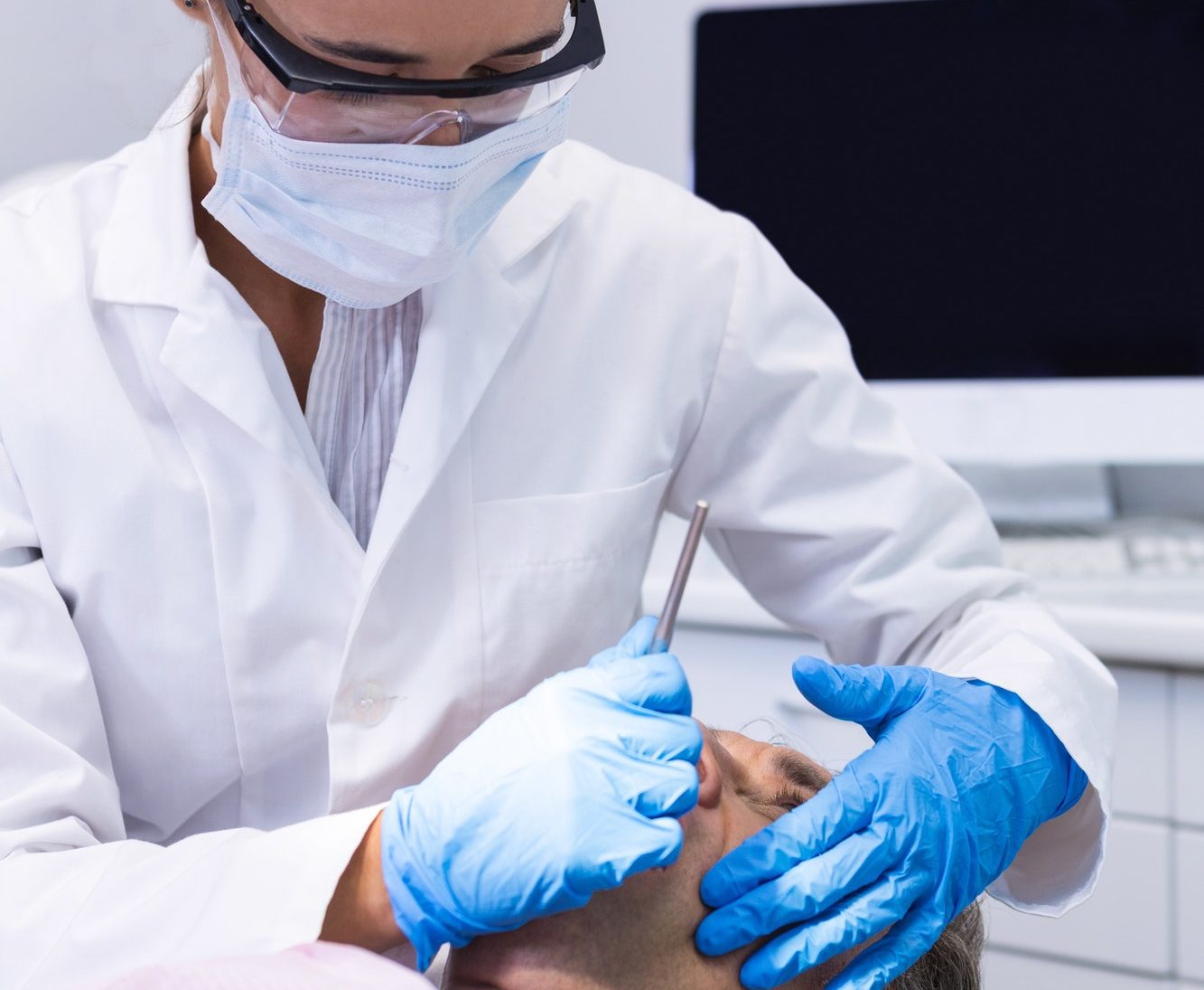Man receiving dental treatment by dentist
